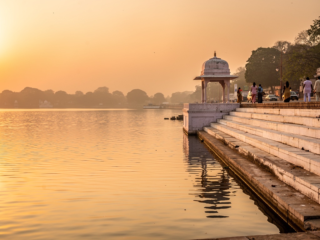 Rankala Lake at golden hour with a stone pavilion on the bank