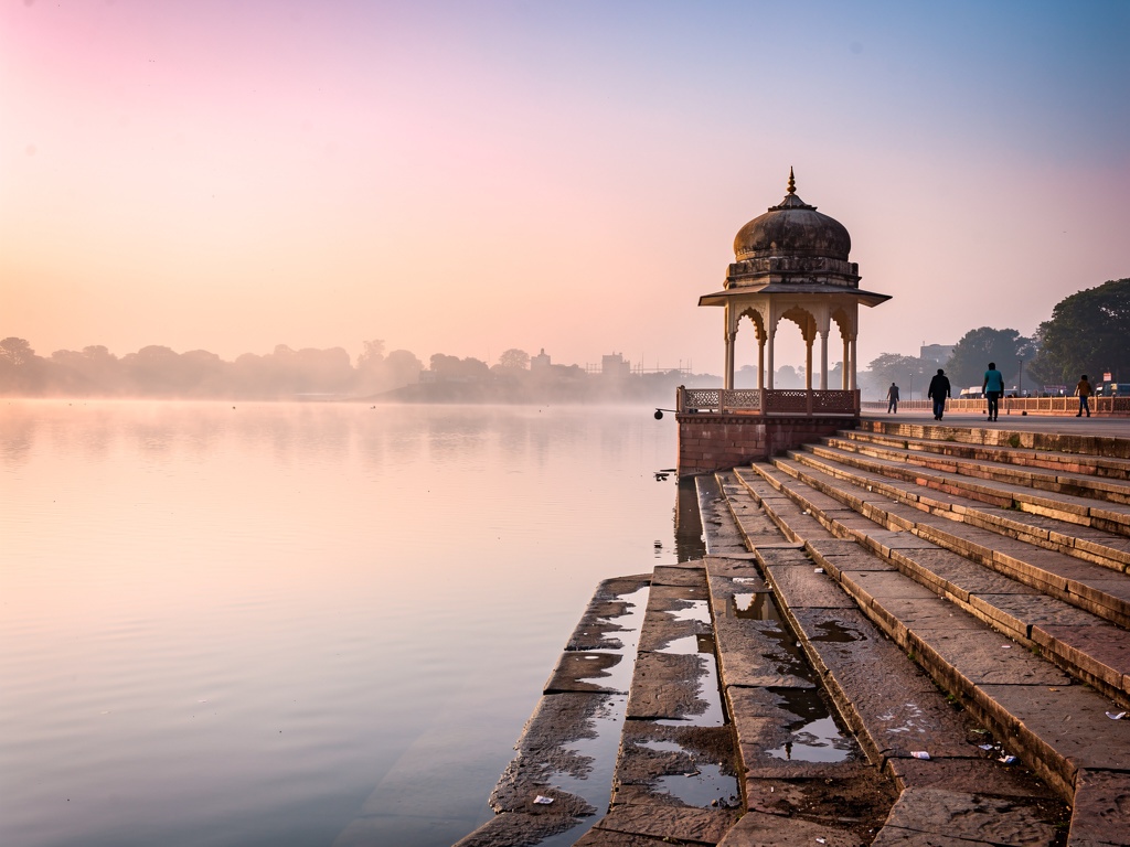 Rankala Lake in the early morning with mist and a pink sky